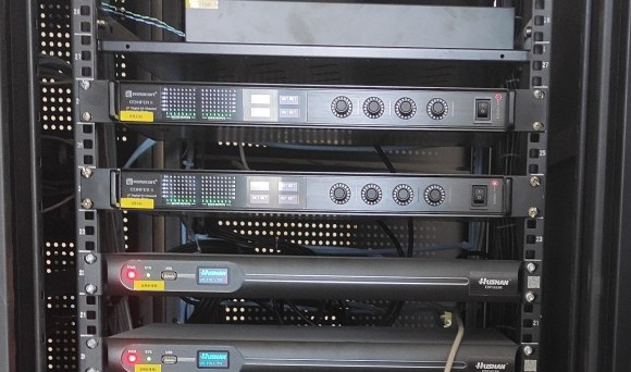 CONFER X Dante digital mixers installed in the equipment rack