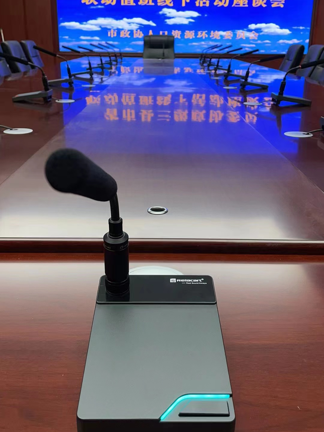 Close-up of the Relacart TDN-1 Dante networked wired microphone on the conference table